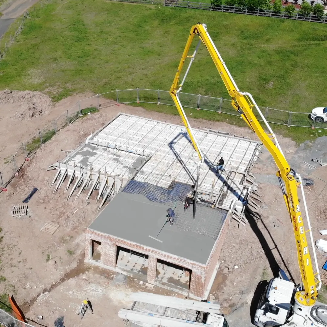 Aerial view of a concrete slab pour on an acreage building site
