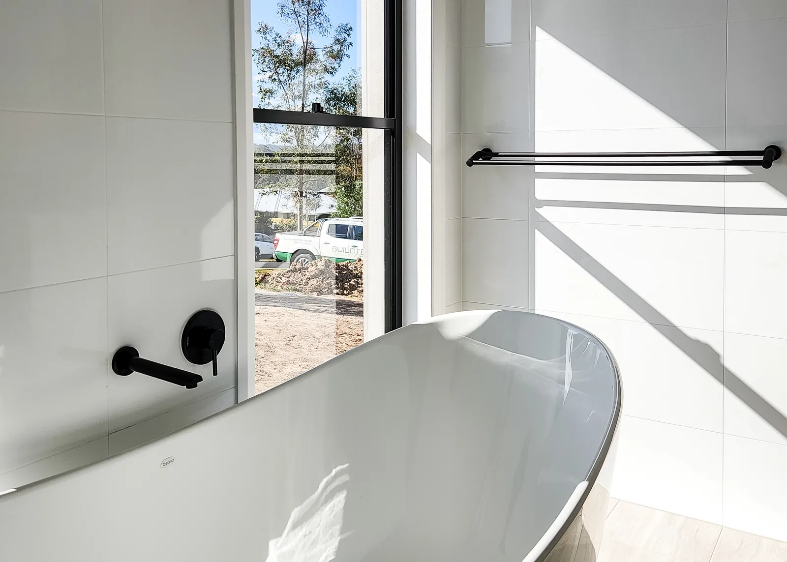Custom home bathroom with freestanding bath beside a window