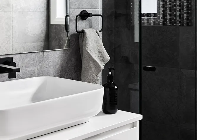 Custom home bathroom vanity with matte black tapware and dark tiled shower