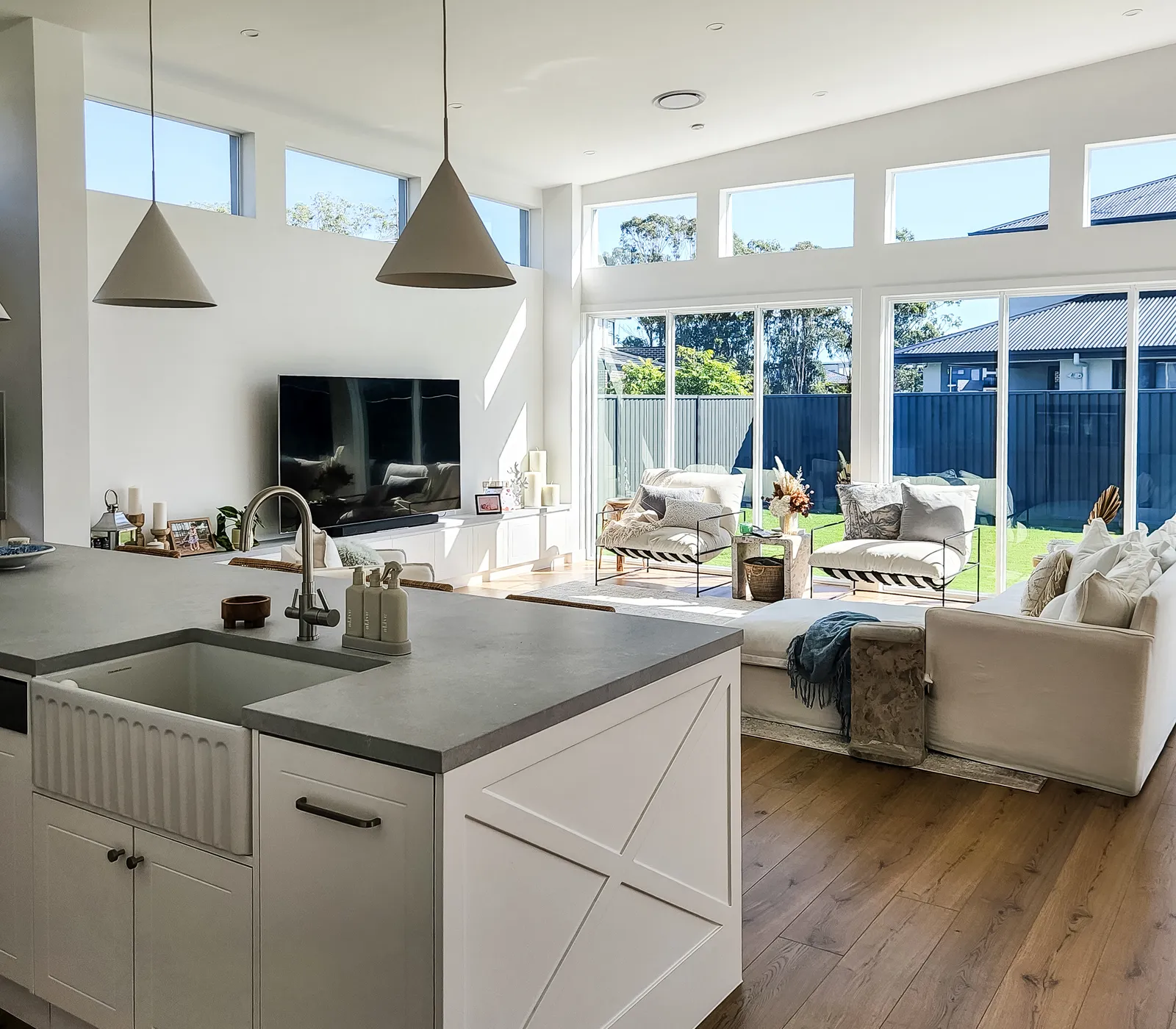 Denham Court custom home kitchen looking through to the living room and backyard