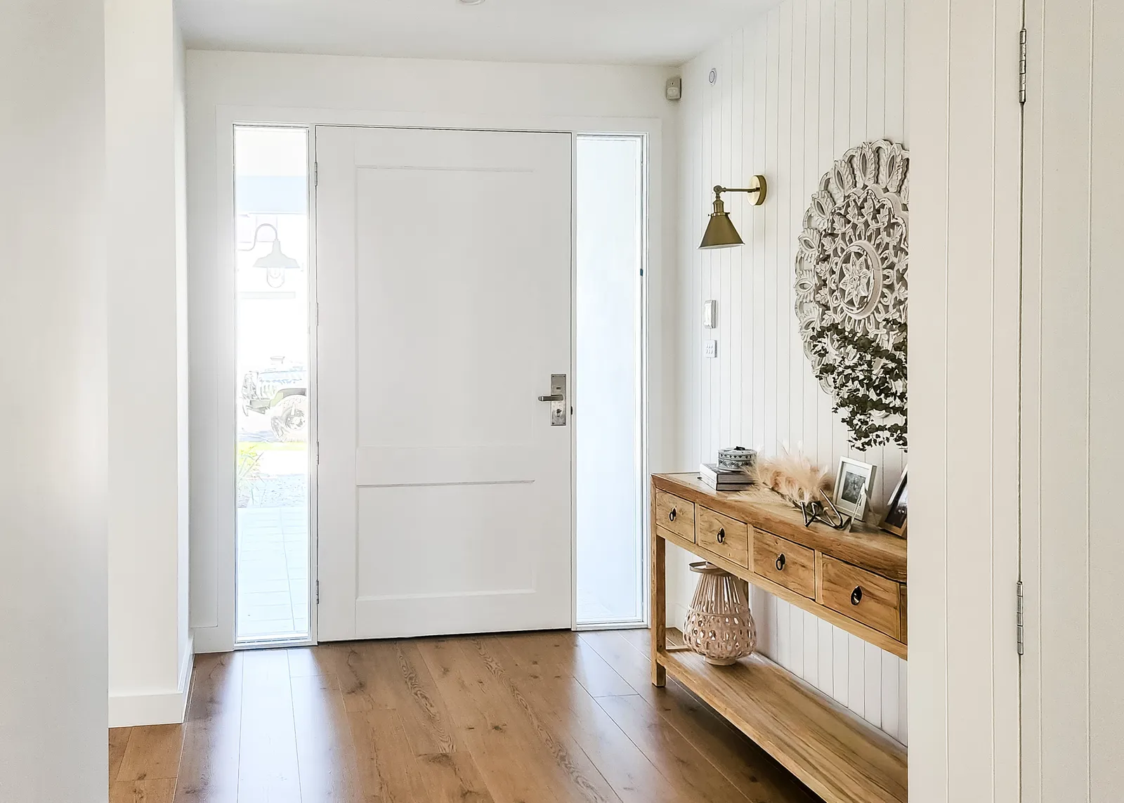 Denham Court custom home entry with timber console and panelled front door