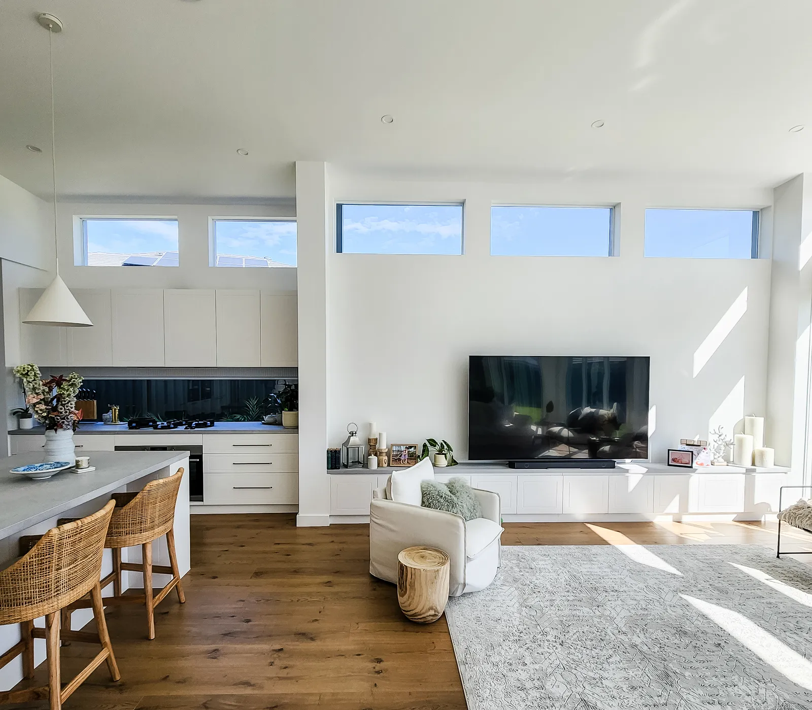 Denham Court custom home open-plan kitchen and living with highlight windows